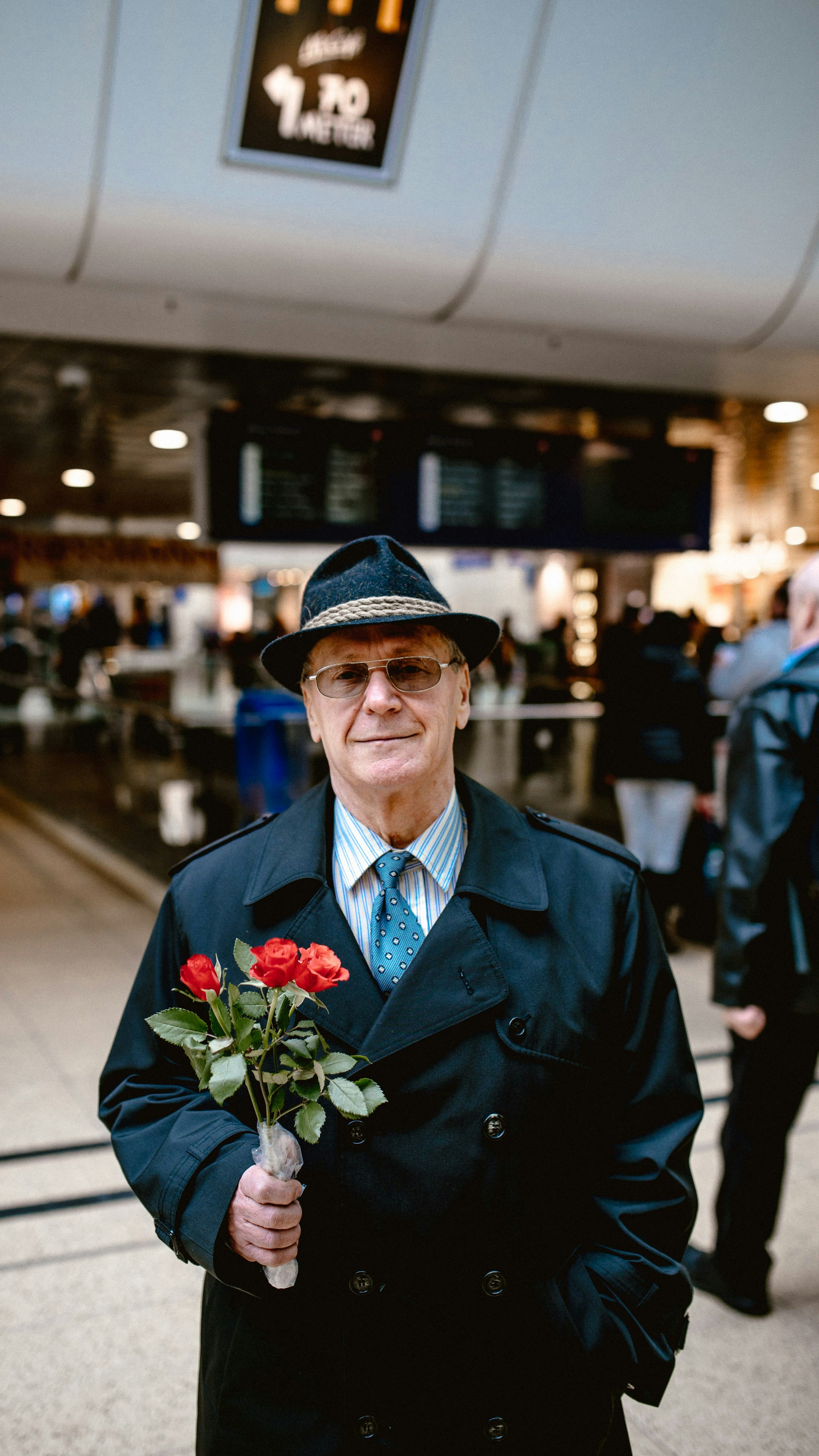 man in blue suit jacket and black hat